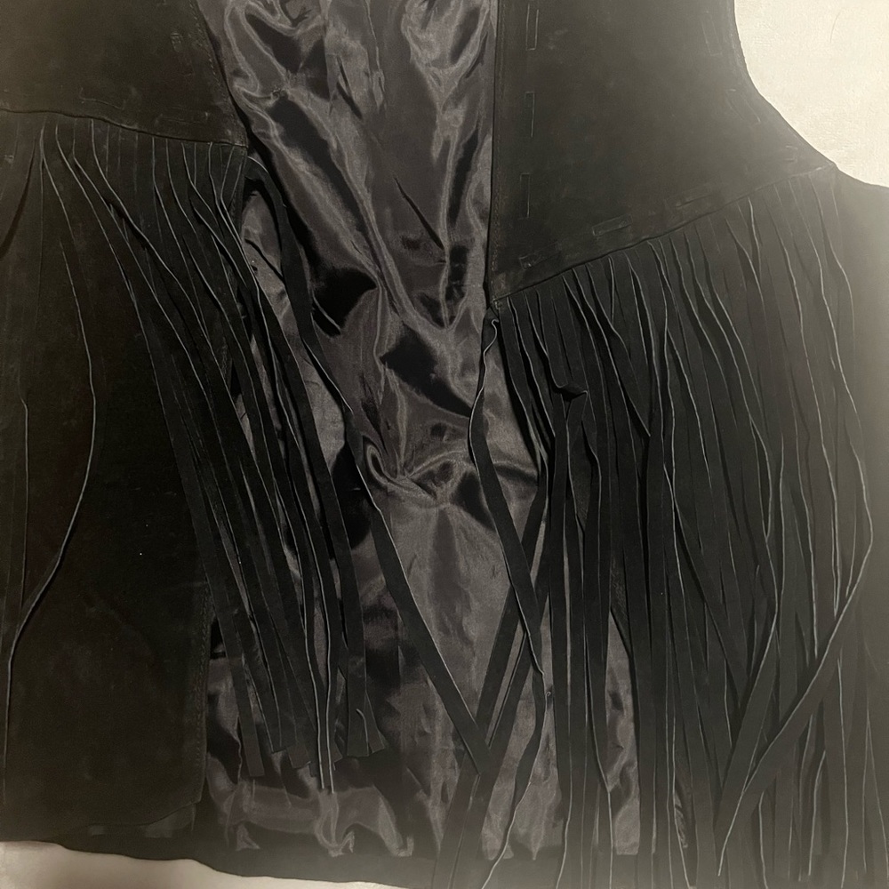 Rampage leather. It’s actually suede.with long fringes